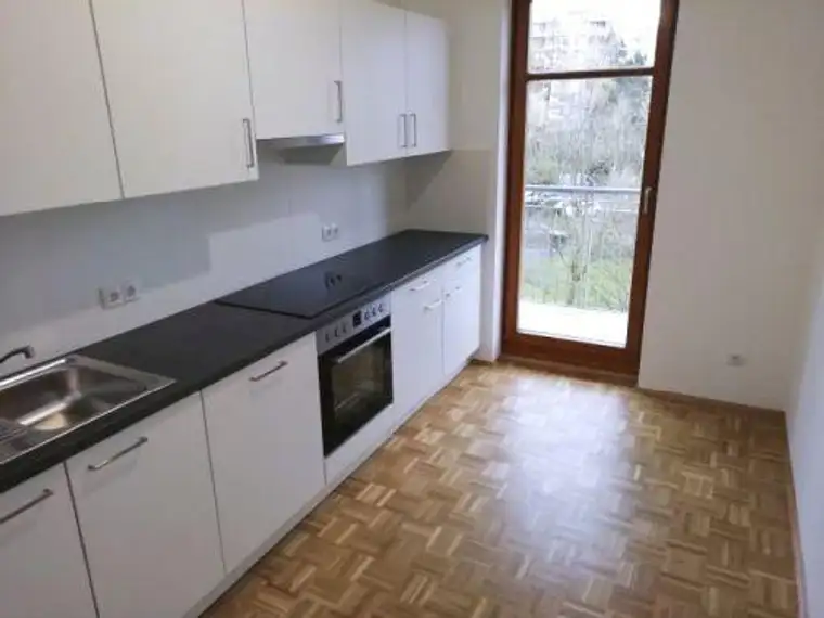 Ruhiger 2 ZIMMER-NEUBAU + Süd-Balkon + extra Küche möbliert + Bad mit Dusche + extra WC + Lift + TG!