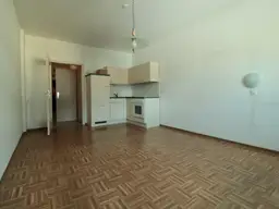 1 Zimmer mit möblierter Küche und Möbeln in Übelbach