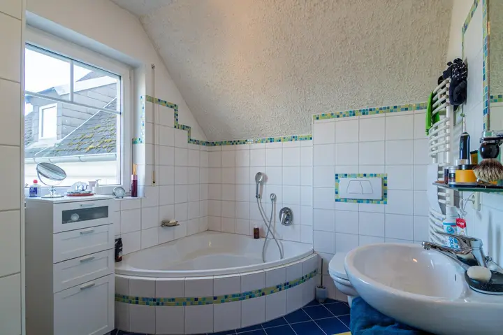 2000er-Charme - Ein Badezimmer mit Dusche, Eckbadewanne & zwei Waschbecken