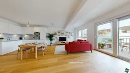 Modernes, offenes Wohnzimmer mit integrierter Küche, Essbereich und Zugang zu einem sonnigen Balkon.