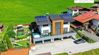 Expose Modernes Einfamilienhaus mit Naturpool &amp; Weitblick – stilvolles Wohnen in Westendorf
