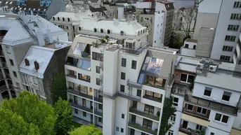 Luftaufnahme des modernen Neubaus mit Dachterrassen und Blick über die Stadt Wien.