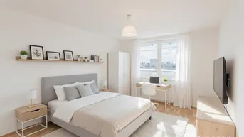 Helles Schlafzimmer mit modernem Bett, Schreibtisch und Fenster mit Blick auf die Stadt.