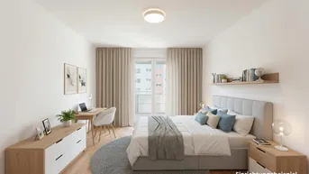 Helles Schlafzimmer mit modernem Bett, Schreibtisch und Zugang zu einem Balkon.