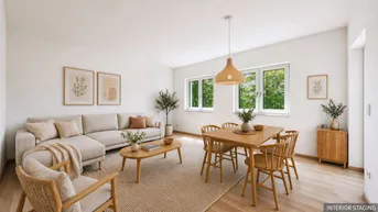 Helles, modern inszeniertes Wohn- und Esszimmer mit Holzboden, bequemer Couch und Blick ins Grüne.