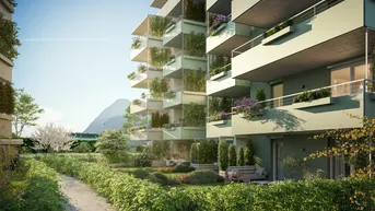 Moderne Wohnanlage mit begrünten Fassaden, Balkonen und gepflegten Gartenwegen.