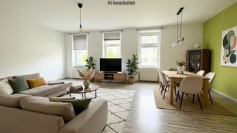 Heller, offener Wohn- und Essbereich mit modernem Mobiliar und grün akzentuierter Wand.