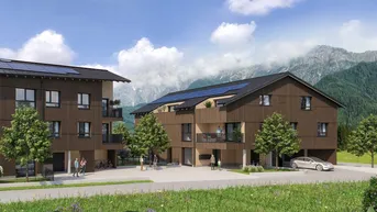Moderne Mehrfamilienhäuser mit Holzfassade, Balkonen und beeindruckendem Bergblick in einer grünen Umgebung.