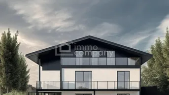 Modernes Einfamilienhaus mit großen Glasflächen, Balkonen und Satteldach in grüner Umgebung.