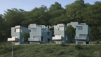 Moderne Reihenhäuser mit kubischer Architektur, eingebettet in eine grüne Hügellandschaft.