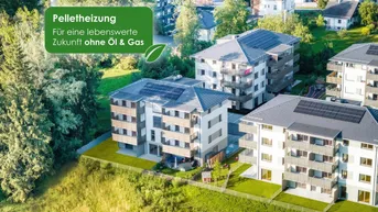 Luftaufnahme von modernen Wohngebäuden mit Solarpaneelen und grüner Umgebung, beworben mit Pelletheizung.