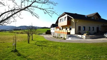 Geräumiges Einfamilienhaus mit weitläufigem Garten und Blick auf die umliegende Landschaft.