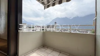 Geräumiger Balkon mit Markise und beeindruckendem Blick auf die Berge und die Stadt.