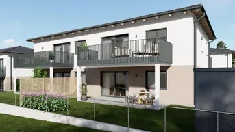 Moderne Fassade eines Neubaus mit Balkonen und Terrassen in ländlicher Umgebung.