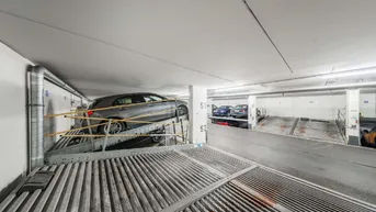 Ein Auto auf einer der Parkplattformen in der modernen Tiefgarage, bereit zum Parken.