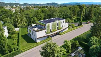 Moderne Wohnanlage mit Photovoltaikanlage, begrüntem Dach und Terrassen in grüner Umgebung.