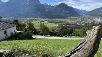 Idyllischer Ausblick auf die Bergwelt und das Tal, mit einem Haus im Vordergrund.