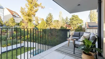 Geräumiger Balkon mit modernen Gartenmöbeln, Blick ins Grüne und auf den Gartenbereich.