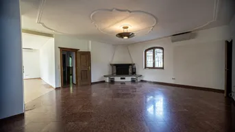 Helles Wohnzimmer mit Marmorboden, dekorativer Stuckdecke und traditionellem Kamin.