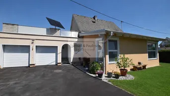 Vorderansicht des Hauses mit Doppelgarage, Auffahrt und Solaranlage auf dem Dach.