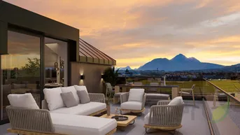 Große möblierte Dachterrasse mit atemberaubendem Bergblick bei Sonnenuntergang, ideal zum Entspannen.