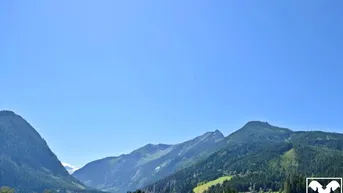 Expose Baugrundstück mit malerischer Bergkulisse