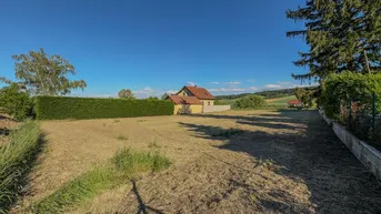 Weitläufiges Grundstück mit Blick auf die umliegende Landschaft und angrenzende Häuser.