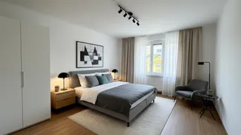 Helles Schlafzimmer mit Doppelbett, Nachttischen, Kleiderschrank und modernem, minimalistischem Design.