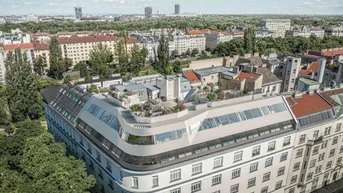 Moderne Architektur mit geschwungener Dachkonstruktion und Dachterrassen in urbaner Umgebung.