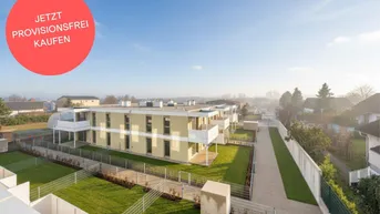 Luftaufnahme eines modernen Wohnkomplexes mit gepflegten Grünflächen und umliegender Bebauung.
