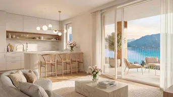 Heller offener Wohnbereich mit moderner Küche, Parkettboden und Zugang zu einer Terrasse mit Seeblick.