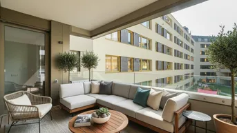 Gemütlicher Balkon mit bequemen Outdoor-Möbeln und Blick auf die umliegenden Gebäude.