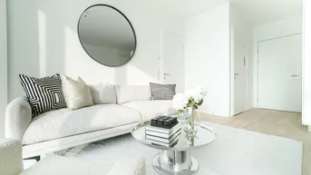 Helles, modern eingerichtetes Wohnzimmer mit weißem Sofa, rundem Spiegel und minimalistischem Design.