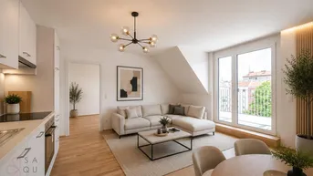 Modernes, offenes Wohnzimmer mit integrierter Küche, Essbereich und Zugang zu einem sonnigen Balkon.