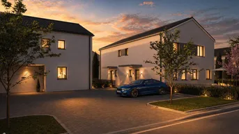 Moderne Reihenhäuser mit gepflasterter Einfahrt und Abendbeleuchtung bei Sonnenuntergang.