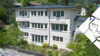 Großzügiges Anwesen mit mehreren Balkonen und gepflegtem Garten in alpiner Umgebung.