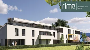 Moderne Wohnanlage mit weißer Fassade, Balkonen und begrünten Außenbereichen, umgeben von Bäumen.