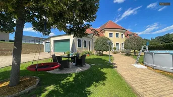 Großer Gartenbereich mit Sitzgelegenheiten, Bäumen und einem Aufstellpool vor dem Haus.
