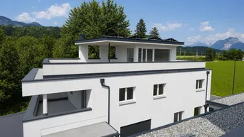Modernes Gebäude mit Flachdach und weitem Blick auf die umliegende Berglandschaft.