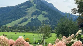 Expose Wohnen, wo andere Urlaub machen - 4 Zimmer-Gartenwohnung mit großer Terrasse in Kössen