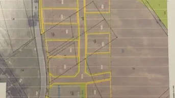 Übersicht des Teilungsvorschlags für mehrere Baugrundstücke mit angrenzender Straße und Grünflächen.