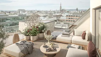 Großzügige Dachterrasse mit Lounge-Möbeln, Pflanzen und weitem Blick über die Stadt.