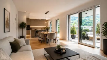 Heller, offener Wohn-Essbereich mit moderner Küche, Holzboden und Zugang zur Terrasse.
