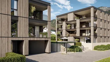 Moderne Mehrfamilienhäuser mit Holzfassade, Balkonen und Tiefgaragenzufahrt in alpiner Umgebung.