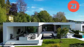 Moderne Architektur mit weitläufigem Garten und großzügiger Terrasse, umgeben von grüner Landschaft.