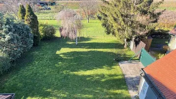 Großer, gepflegter Garten mit Rasenfläche und Blick ins Grüne, ideal für Erholung im Freien.