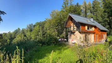 Charmantes Holzhaus in idyllischer Waldrandlage mit weitem Blick über die Landschaft.