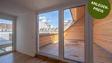 Helles Zimmer mit Holzboden und Zugang zu einer großen Holzterrasse mit Stadtblick.