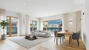 Helles Wohn- und Esszimmer mit Holzboden, modernen Möbeln und weitem Blick auf die Berge.