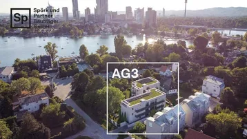 Luftaufnahme der Wohnanlage AG3 mit Blick auf die Stadt und den See.